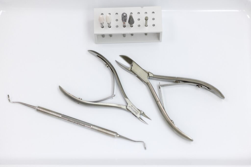 Pedicure and manicure tools close-up, top view. Pliers, cutters, Curette for pedicure