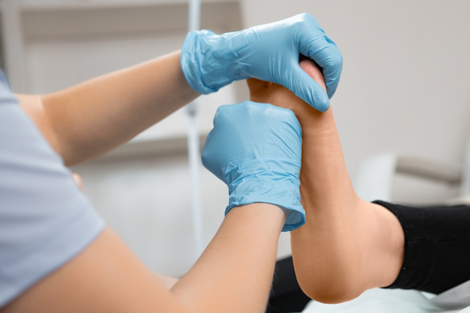 Podiatrist doing therapeutic foot massage at beauty salon