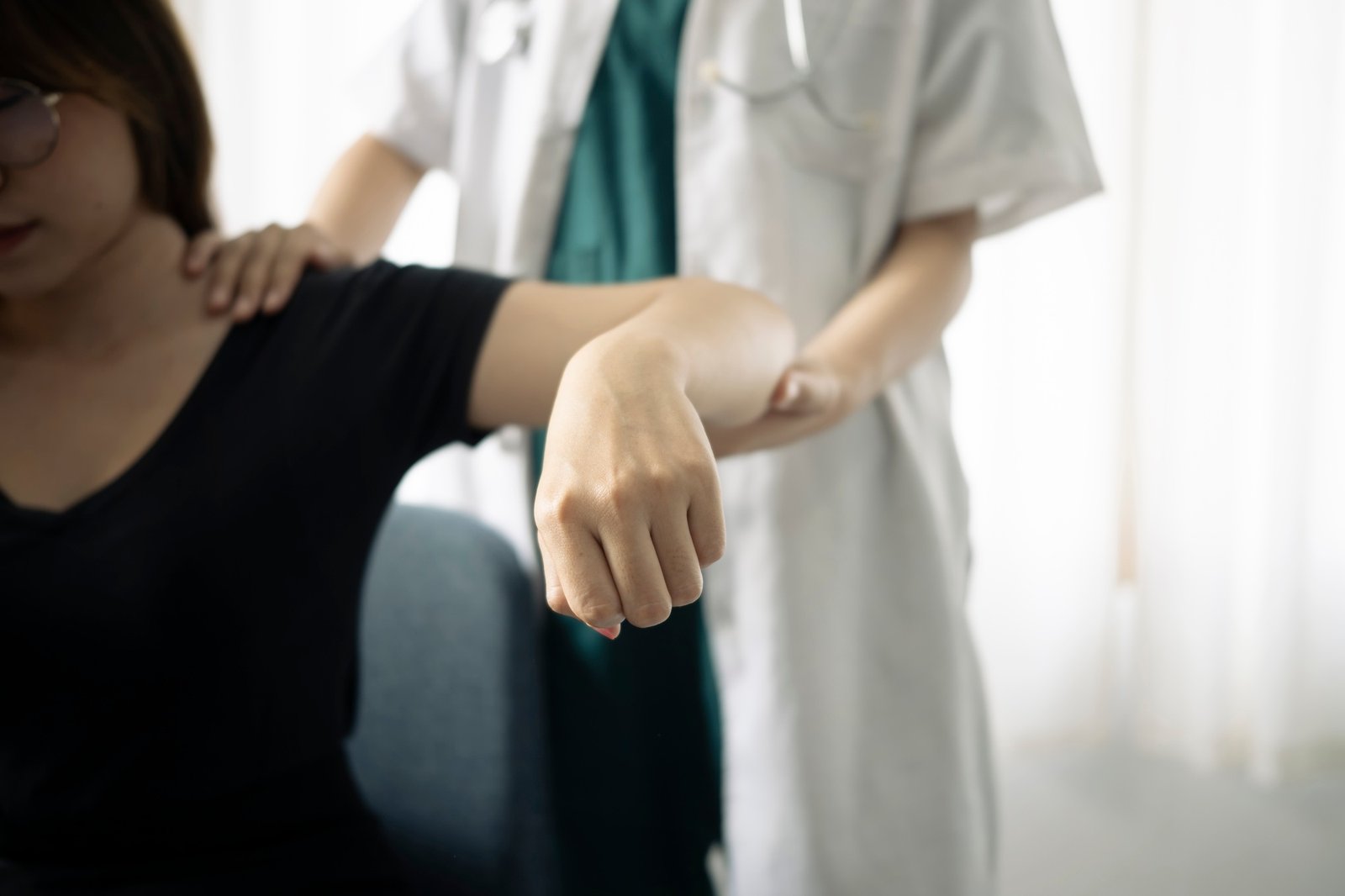 Shot of physiotherapist helping patient to do exercise in physios room.