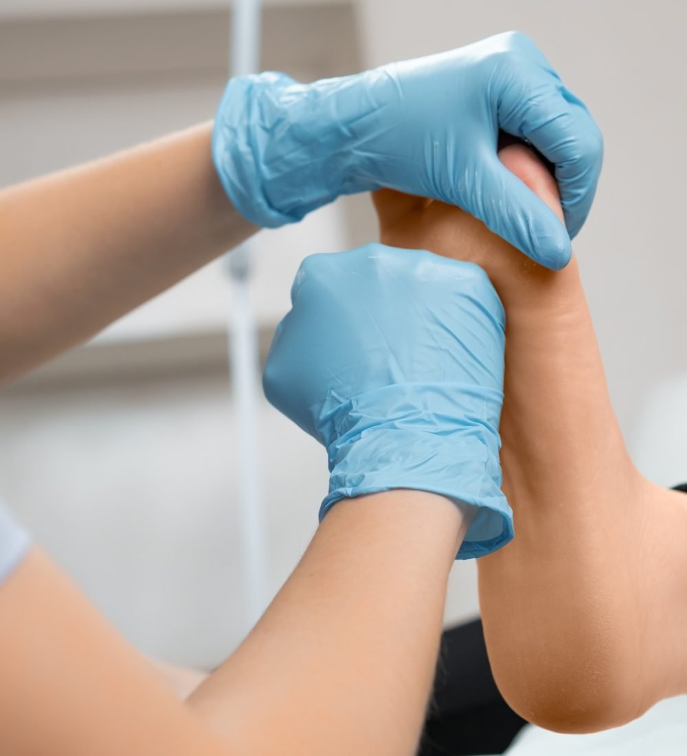 Podiatrist doing therapeutic foot massage at beauty salon