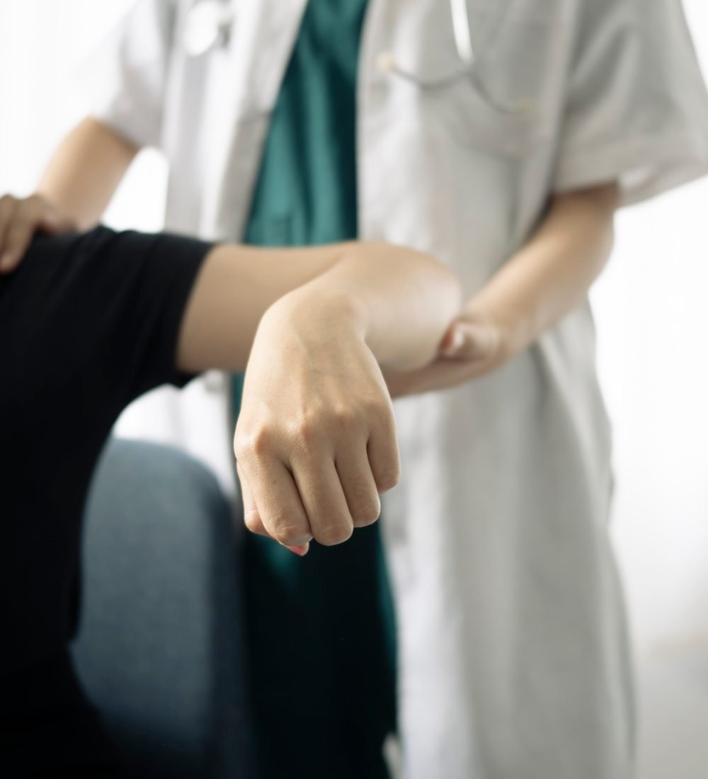 Shot of physiotherapist helping patient to do exercise in physios room.